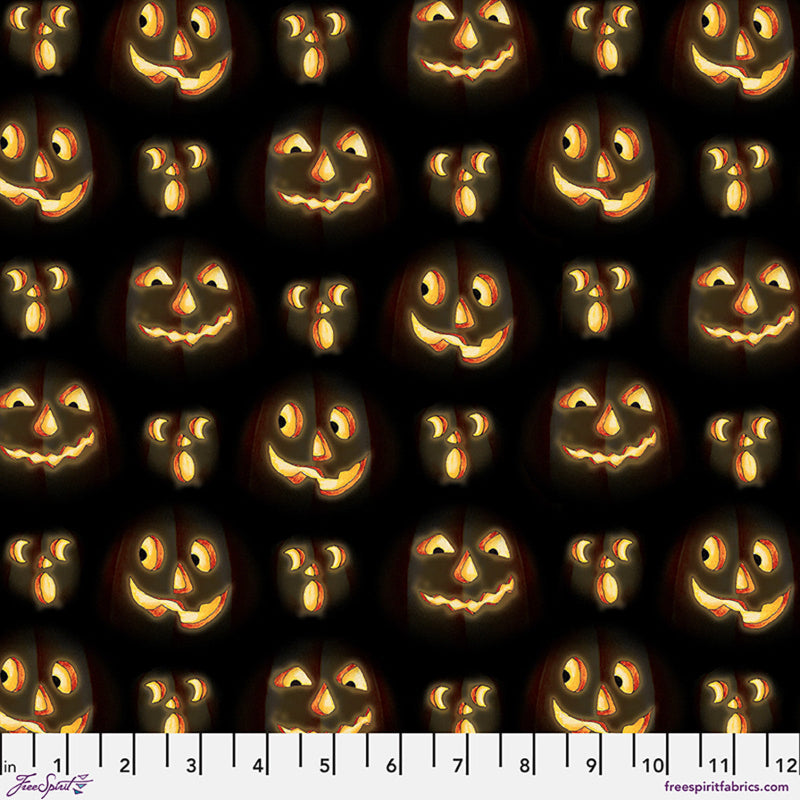Fabric with pattern of glowing jack-o'-lantern faces on a black background.