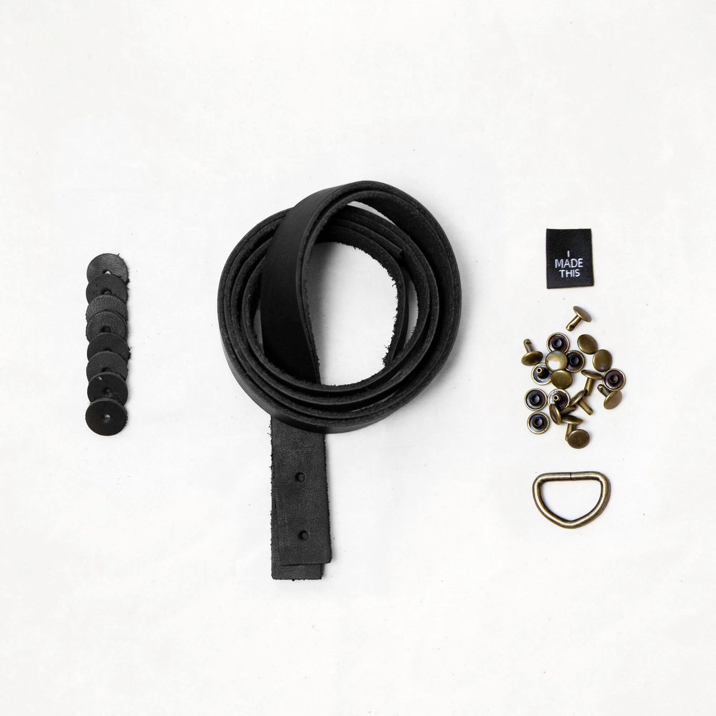 Black leather strap with hardware components on a white background