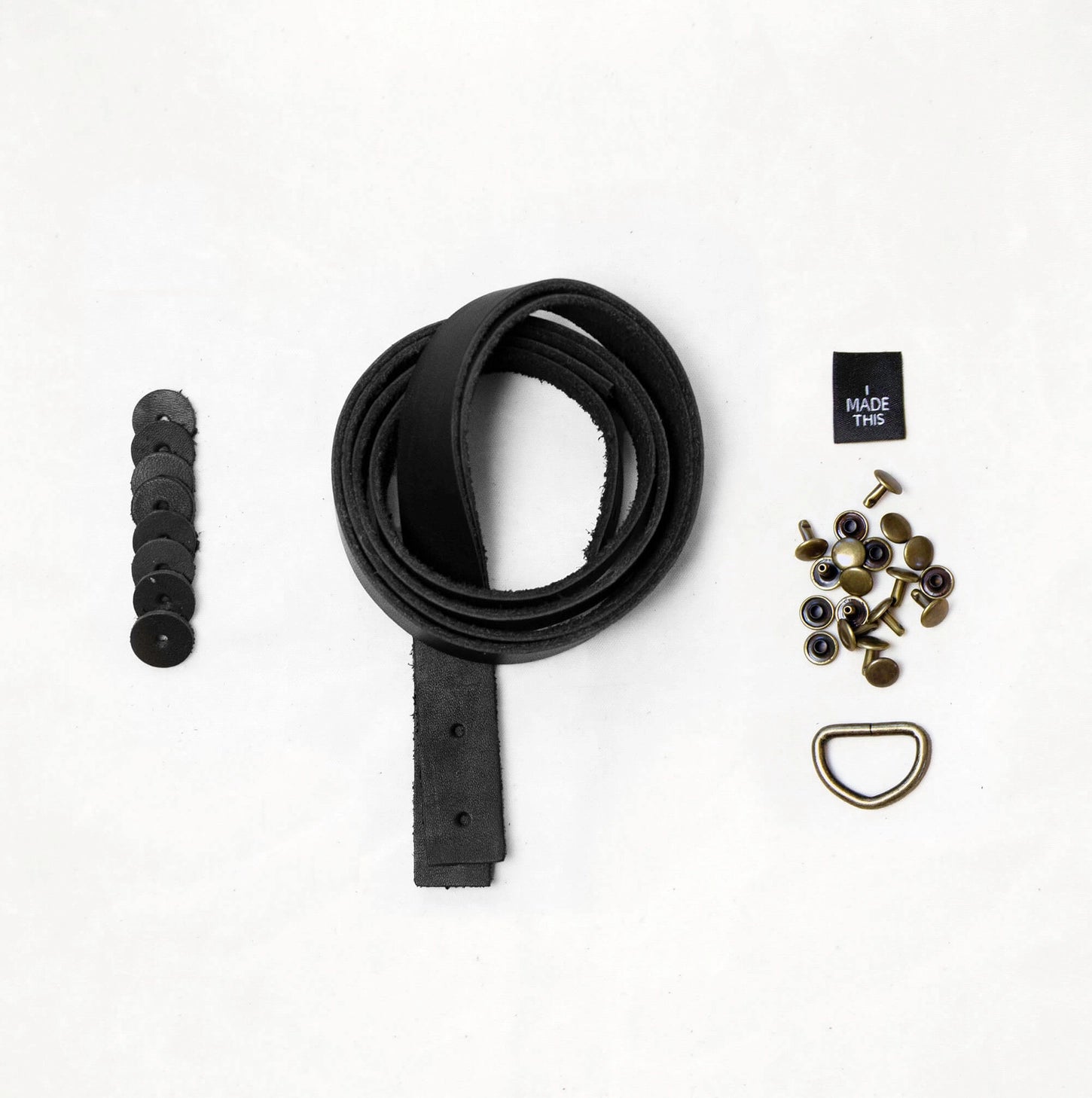 Black leather strap with hardware components on a white background