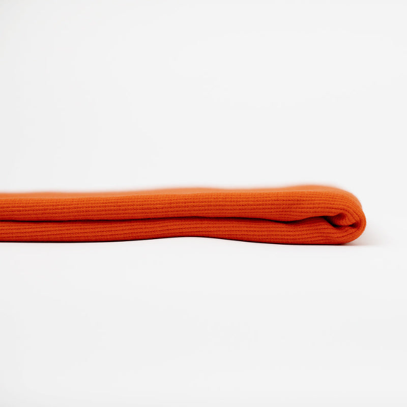 Folded orange fabric on a white background