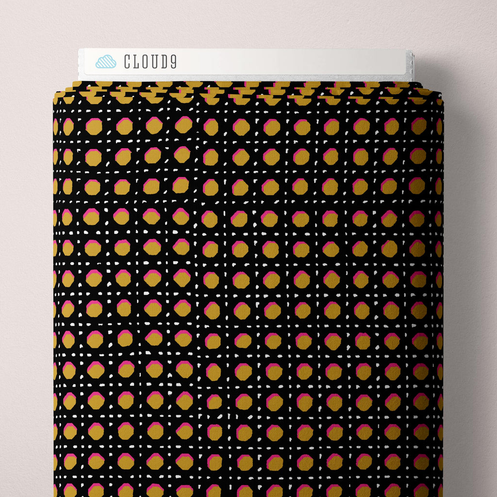 Graphic pattern resembling chair caning in black on gold background with pink and white highlights.