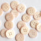 Pale pink buttons arranged on a white background