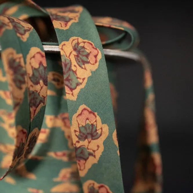 Floral-patterned bias tape on a dark background