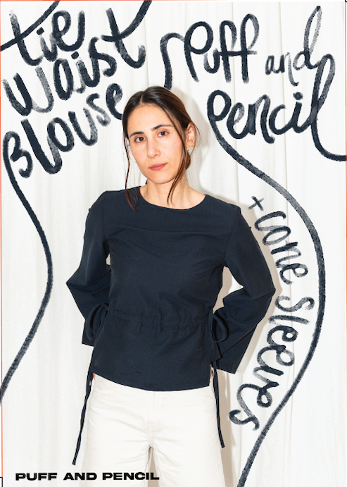 Person wearing a dark blue blouse with text on a white background