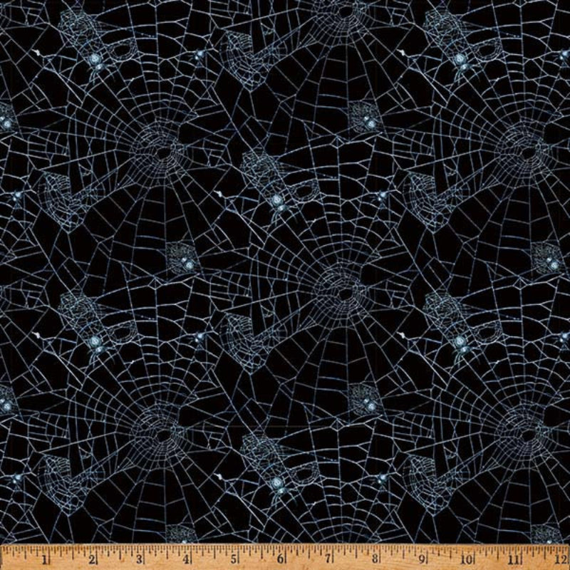 Spider web pattern on black fabric.