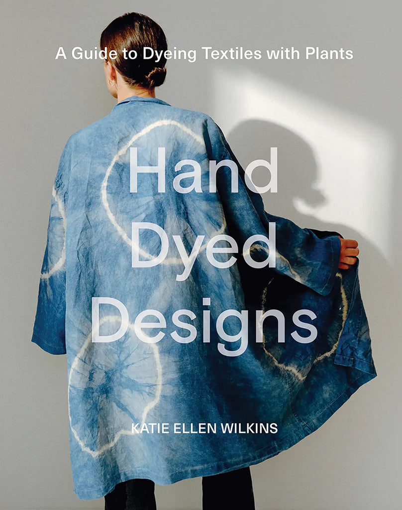 Book cover titled 'Hand Dyed Designs' with image of a woman in a blue dyed overshirt on a white background