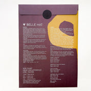Sewing pattern package 'Belle Hat' with text and a silhouette of a person wearing a hat.