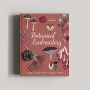 The book cover of 'Botanical Embroidery' by Arumma Bloomers is shown against a neutral light gray background. The cover features a dusty rose background decorated with various embroidered botanical designs, including flowers, leaves, and mushrooms.