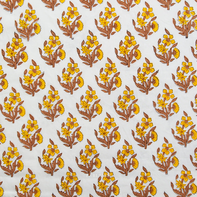 Pattern of yellow flowers with brown stems on a white fabric