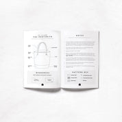 Open book showing a pattern for a bag with text and icons on a white background