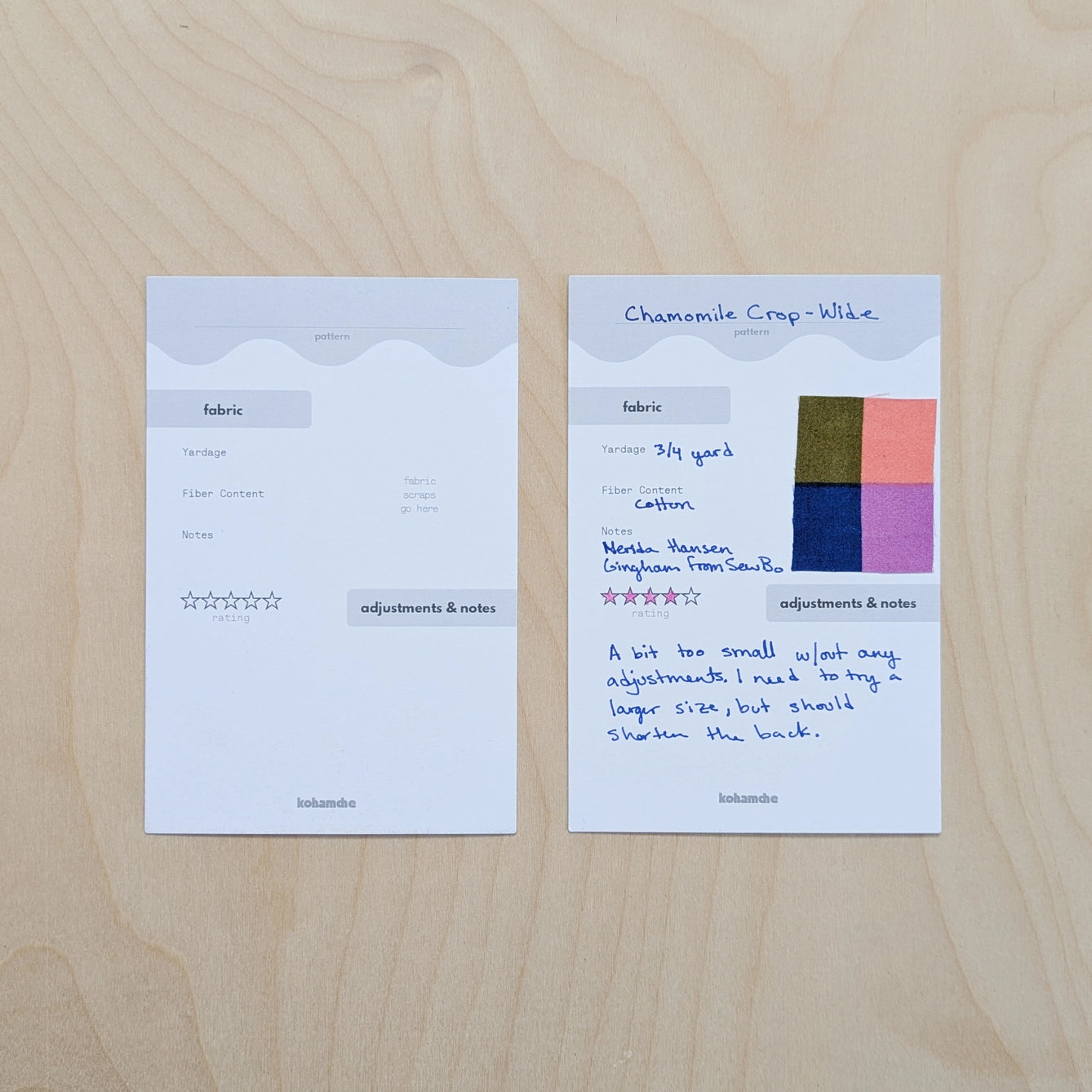 Two fabric swatch cards on a wooden surface with text and color samples.