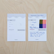 Two fabric swatch cards on a wooden surface with text and color samples.
