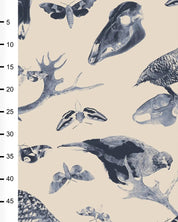Pattern of animal skulls, birds, and antlers on a beige fabric with a ruler on the side.