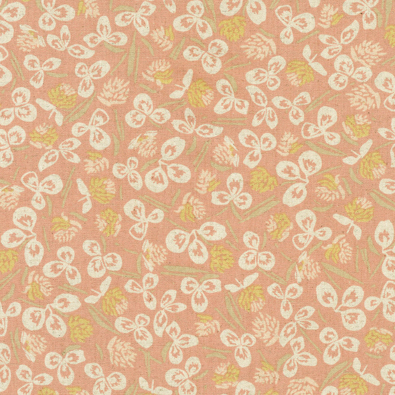 Orchard Run Patterned fabric with white floral and bow designs on a pink background