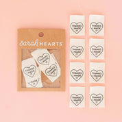Packaging of 'Thanks I Made It' heart-shaped stickers by Sarah Hearts on a pink background.