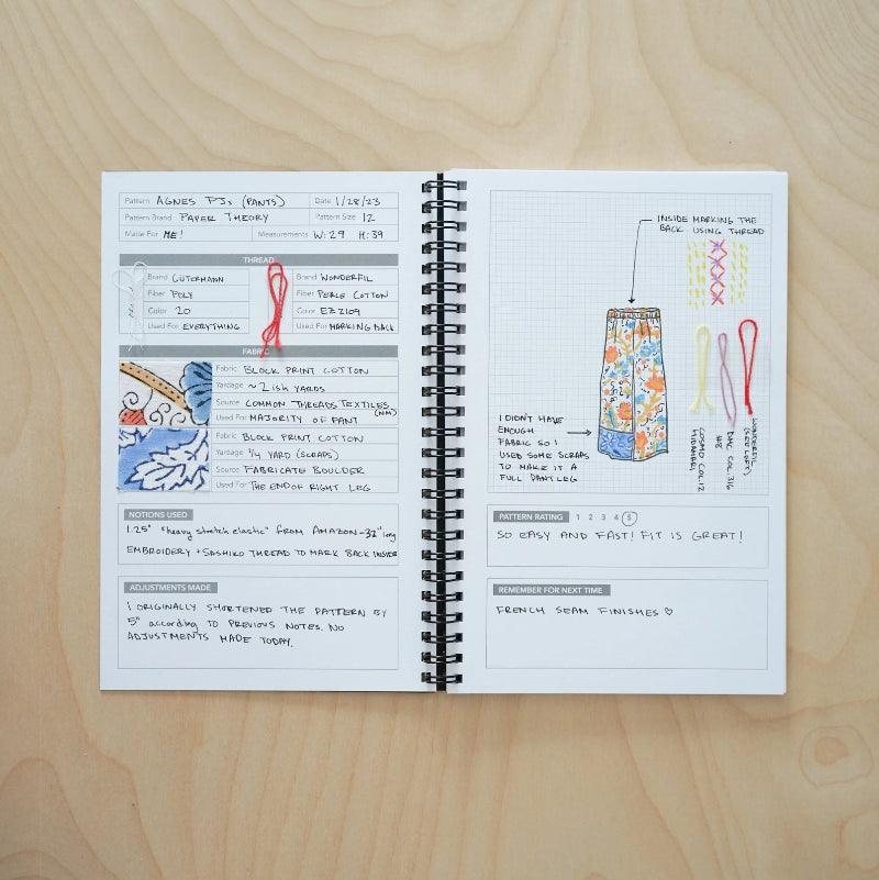 Open notebook with design sketches and notes on a wooden surface