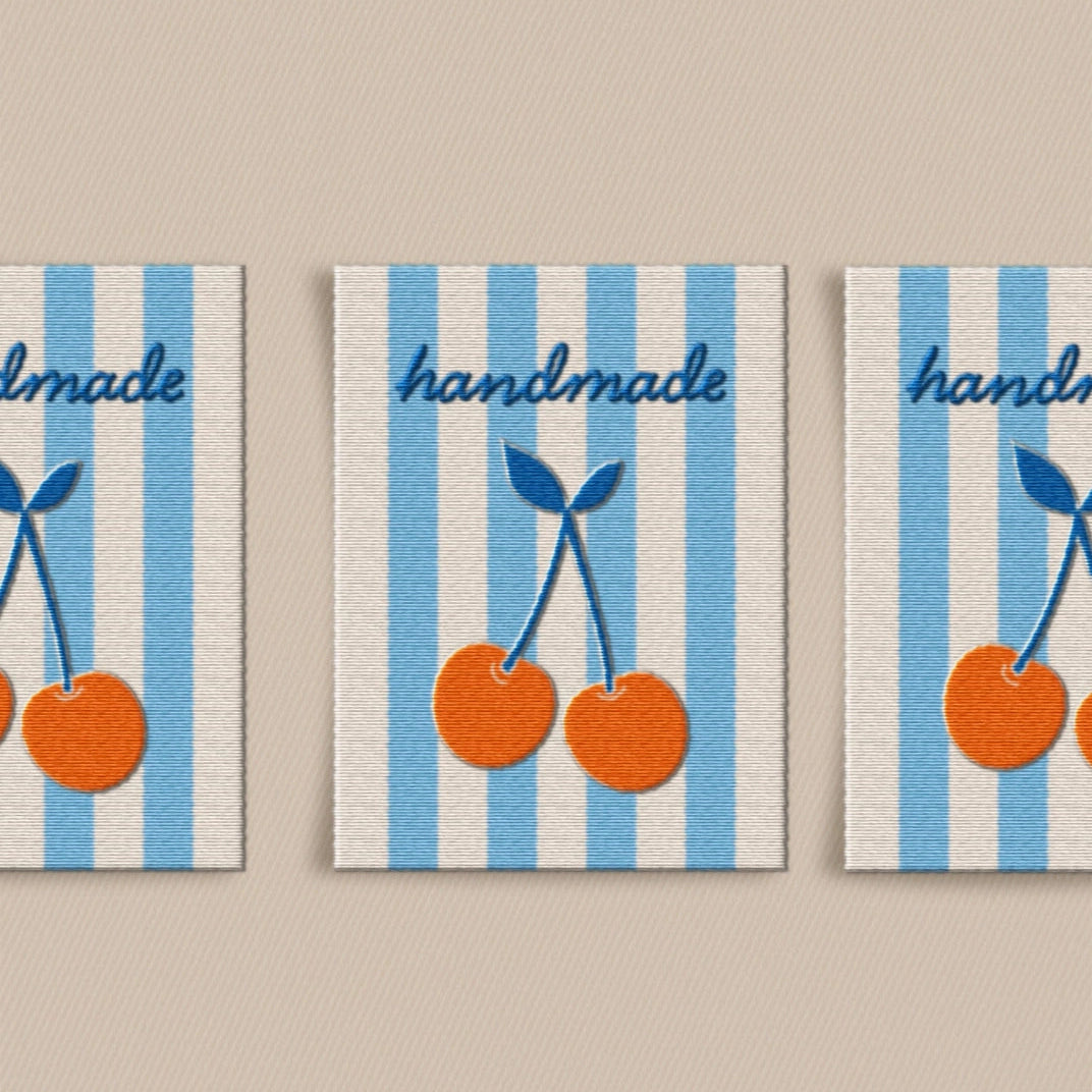 Three labels with blue and white striped pattern and orange cherries, labeled 'handmade'.