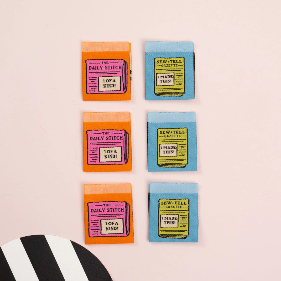 Set of colorful labels with text on a light pink background