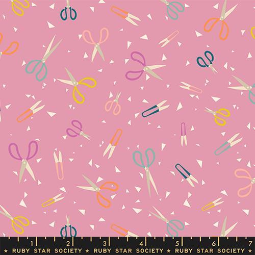 Pattern of colorful scissors on a pink background with a ruler at the bottom.