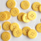 Yellow buttons scattered on a white background